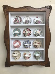 a wooden shelf with many different plates on it's sides and an ornate frame