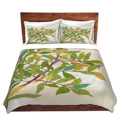 an image of a bed with green leaves on the comforter and pillow cover set