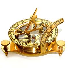 a gold colored compass on a white background