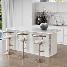 three stools in front of a marble topped kitchen island with white walls and wood flooring