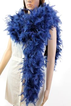 a mannequin wearing a blue feather scarf