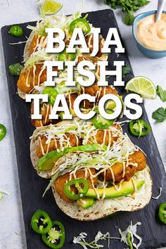 three fish tacos with jalapenos, limes and mayonnaise