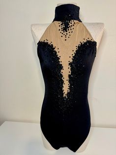 a mannequin with black and gold sequins on it's back