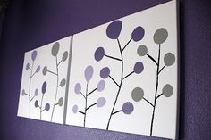 three paintings are hanging on the wall in front of a purple and white background,