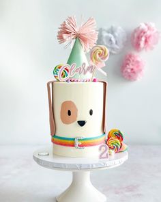 Puppy cake with rainbow details and party hat Puppies Cake Ideas, Dog Theme Cupcakes Puppy Party, Puppy Bday Cake, Dog Party Cake Ideas, Rainbow Puppy Cake, Rainbow Puppy Birthday Party, Puppy Party Cupcakes, Puppy Birthday Party Decorations, Diy Puppy Cake