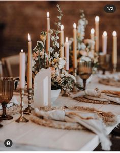 a table topped with lots of candles and flowers