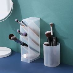 the makeup brush holder is holding several brushes