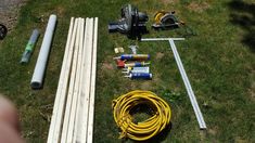 the tools are laid out on the grass next to some wood planks and wires