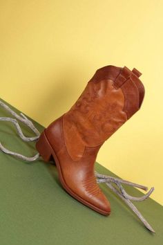 Yee ha! Step into a stylish Autumn with these beauties! Our Jolene Cowboy Boots are made from a gorgeous, practical PU and are a classic cowboy style with a low heel, high top and pointed toe, in a gorgeous, caramel brown. She features contrasting brown panels with beautiful stitching on the top of the foot and up the sides, making her a truly stunning addition to your Autumn wardrobe. Try pairing her with our Violet Vintage Fleur Swing Dress and a headscarf for a quirky, but fashionable day-tim Brown Country Style Heeled Boots For Fall, Country Style Brown Mid-calf Boots For Fall, Fall Rodeo Brown Mid-calf Boots, Western Brown Mid-calf Boots For Fall, Western Style Brown Mid-calf Boots For Fall, Winter Brown Heeled Boots For Rodeo, Brown Pointed Toe Heeled Boots For Rodeo, Western Low Heel Boots For Fall, Western Brown Mid-calf Boots With Almond Toe