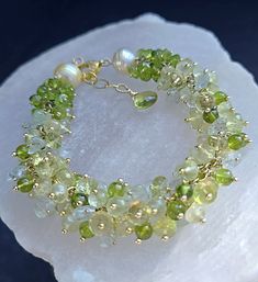 Golden South Seas Pearls Lemon Quartz Bracelet with Peridot and Prehnite on Gold Vermeil Diamond Pave Clasp Gift for Her   Like fresh lemons and limes, dozens of sparkling, bright and cheery lemon quartz rondelles with beautiful micro faceting, peridot rounds, faceted prehnite rondelles and peridot rondelles are wire wrapped onto gold filled chain.  Also there are also aquamarine carved leaves adding dimension to this one of a kind bracelet.  On each end of the bracelet there's a cluster of just peridot and a gorgeous 12mm golden south seas pearls. A statement bracelet you'll get many compliments.  A beautiful diamond crusted gold vermeil lobster claw clasp.  Length as shown is 8"  This is made to order.  Please read policies prior to ordering. Please allow 2 weeks for custom orders ⚜Mater Antique Pearl Necklace, Lemons And Limes, Diy Jewelry Unique, Peridot Jewelry, Beads Bracelet Design, Jewelry Lookbook, Lemon Quartz, South Seas, Statement Bracelet