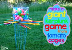 a sign that says make a giant gummy park game from tomato cages on the grass