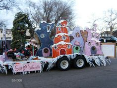 a truck with decorations on the back driving down a street