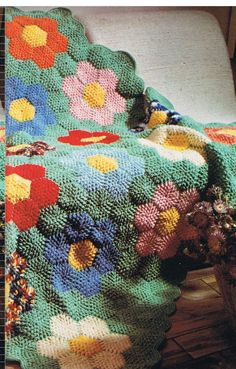 a crocheted blanket is sitting on a chair