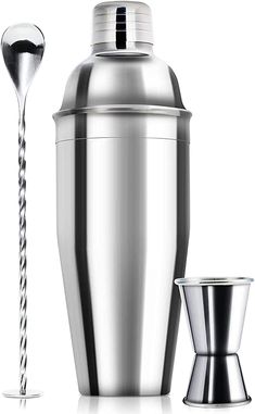 a cocktail shaker, cup and spoon on a white background