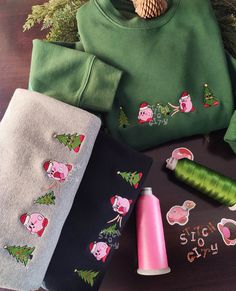 various christmas sweaters and accessories on a table