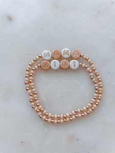 Angela Holm X Just Bead it by Rachel Treat yourself and your mini to the perfect accessory duo: Mama and Mini Neutral Bracelets! Whether you're rockin' a tan and white combo, complete with gold letter beads, or go for a classic 14k gold filled look – these one-of-a-kind bracelets from Angela Holm X Just Bead it by Rachel are exactly what you and your little one need to make a fashion statement any day of the week! This set comes with one Mama Bracelet and you can chose how many mini bracelets yo Mama Mini Bracelet, Diy Mama Bracelet, Mama And Me Bracelets, Dainty Gold Friendship Bracelet With Letter Beads, Mama And Mini Bracelets, Trendy Everyday Rose Gold Beaded Bracelets, Trendy White Stretch Bracelet For Mother's Day, Dainty Adjustable Stretch Bracelet With Letter Beads, Trendy Gold Beaded Bracelet For Birthday