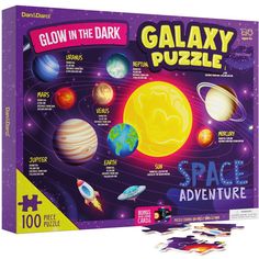 the glow in the dark galaxy puzzle is shown with space and planets on it's side