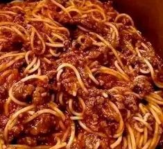 a box filled with spaghetti and meat sauce