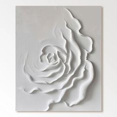 a large white rose is shown on the wall