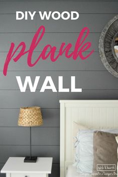 the diy wood plank wall is painted in pink and gray