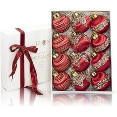 red and gold christmas ornaments in a white box