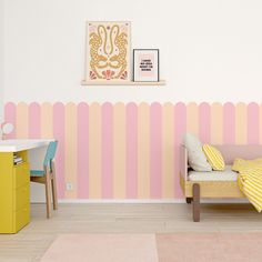 a small child's bedroom with pink, yellow and white stripes on the wall