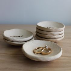 wedding rings are placed in small bowls on a table