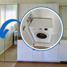 a white washer sitting inside of a bathroom next to a dryer and cabinets