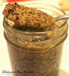 a glass jar filled with food sitting on top of a white countertop next to a spoon