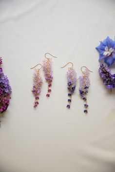 An absolutely beautiful pair of earrings, these earrings have over 50 tiny glass blown flowers that are perfectly placed to create a stunning gradient of petals that resemble the infamous wisteria flower. These earrings dangle beautifully in the sun. Like flowers, each pair of earrings are one of a kind! please allow for slight differences between pairs ! Part of the summer collection - limited stock.  D E T A I L S - 14k gold filled  - tiny 5mm glass blown flowers  - 14 gold filled accents. stamped for authenticity  - lightweight 4 grams for one ear.  - length is 3 inches from top of hook - Earring hook is gentle on the ears and feels secure.  ∙ EXTRAS  - Handcrafted with a lot of love.  - All of my jewelry arrives tightly wrapped.  - If this is a special gift or if you would like a custo Elegant Purple Pressed Flower Earrings, Delicate Purple Flower Earrings, Wisteria Earrings, Wisteria Flower, Lilac Earrings, Earring Hook, Gold Filled Earrings, Floral Earrings, Wisteria