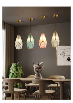 a dining room table with four lights hanging from the ceiling