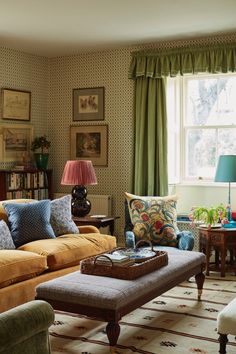 a living room filled with lots of furniture and decor on top of a carpeted floor