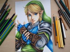 a drawing of the legend of zelda with colored pencils next to it