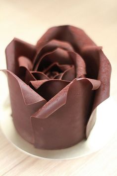 a chocolate flower sitting on top of a white plate