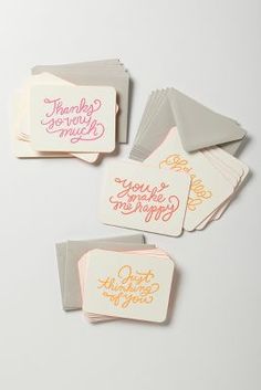 four cards with handwritten words on them, one is white and the other is pink