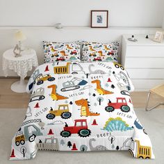 a bed with construction themed sheets and pillows