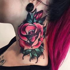 a woman with pink hair has a rose tattoo on her neck and behind her ear