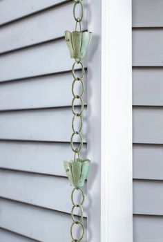 a metal chain hanging from the side of a house