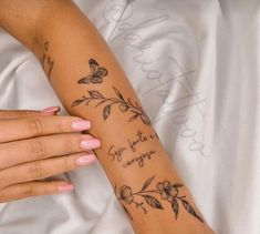 a woman's arm with flowers and butterflies on it that says, you are enough