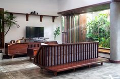 a living room filled with furniture and a flat screen tv on top of a wooden shelf