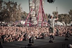 a man standing on top of a stage in front of a crowd