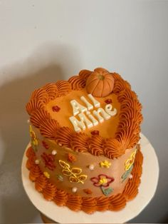 a cake that is sitting on top of a white plate with an orange frosting