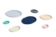 several different colored plates on a white surface