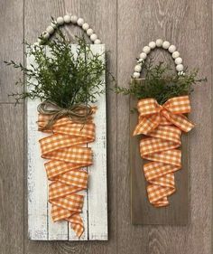 two pieces of wood are decorated with orange and white gingham ribbons, tied together