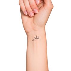 a woman's arm with a small tattoo on the left side of her wrist