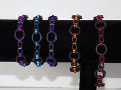 "Rubber stretchy chainmaille bracelets in a new unique pattern called dots and dashes. Made with black EPDM rubber rings and colored anodized aluminum rings. Slip on style stretches over the hand, no clasp, due to the stretchy nature the sizing is approximate. Nickel free jewelry Small fits wrist up to 6.5\"  Medium fits wrists up to 7.5\"  Large fits wrists up to 8.5\"  **more colors available by custom order, other sizes available up on request See other bracelets at RainbowMaille https://www. Dash Pattern, Chainmaille Bracelet, Nickel Free Jewelry, Rubber Rings, Anodized Aluminum, Chain Link Bracelet, Stretch Bracelet, Free Jewelry, Stretch Bracelets