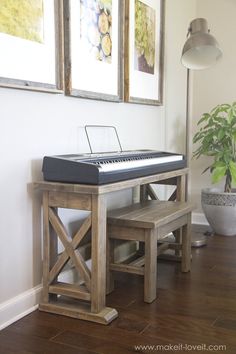 a piano sitting on top of a wooden bench next to a potted plant