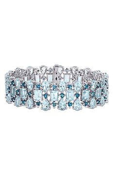 This statement-making bracelet is shimmering with London-blue and sky-blue topaz in different shapes and sizes for visual intrigue. 7 1/2" length; 5/8" width Push-clasp closure Total stone weight: 63.08ct. Sterling silver/blue topaz Imported Wrist Stacks, Blue Topaz Bracelet, Sky Blue Topaz, London Blue Topaz, London Blue, Sterling Silver Bracelet, Silver Blue, Different Shapes, Sterling Silver Bracelets