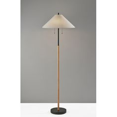 the floor lamp is made from wood and has a white shade on it's top