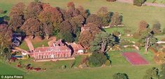 an aerial view of a large house surrounded by trees